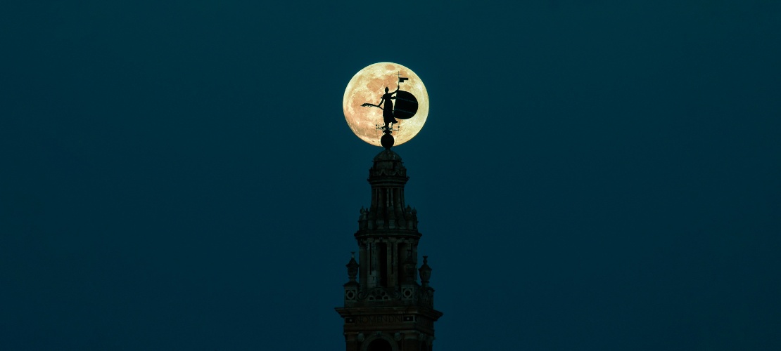 La Giralda silhouetted against the sky at full moon, Seville, Andalusia